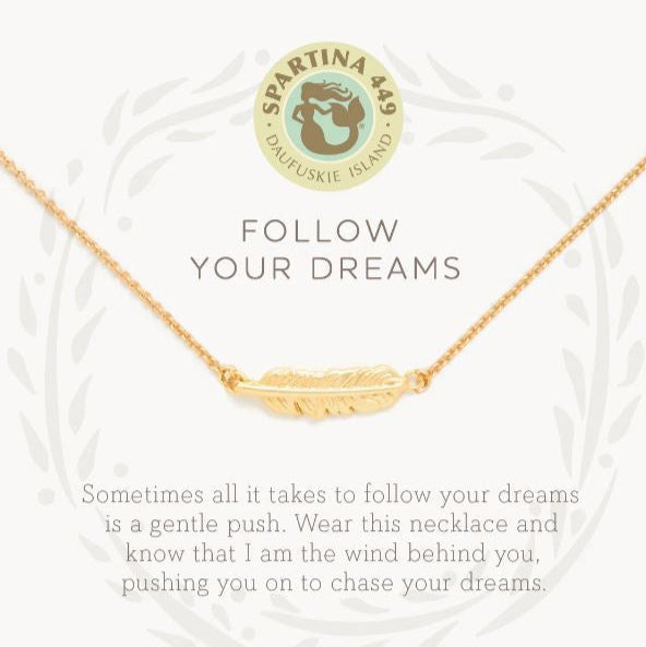 Spartina 449 gold jewelry featuring a delicately textured feather pendant necklace centered on a white background with a faint leaf border, the Daufuskie Island mermaid logo, and the motivational text Follow Your Dreams