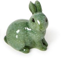 Ceramic figurine by Gunnar Nylund of a small rabbit featuring a glossy mottled green speckled glaze and alert ears on a plain white surface