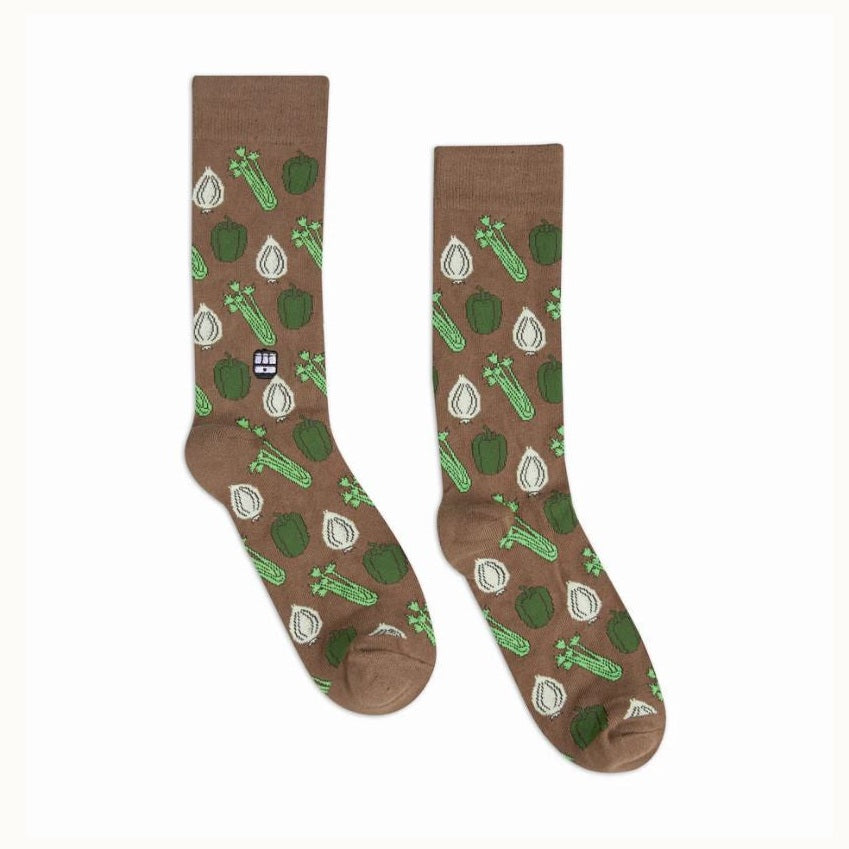 Woven crew socks by Dapper Classics featuring the Cajun Holy Trinity of green bell peppers, white onions, and green celery stalks on a brown background with a small New Orleans streetcar logo