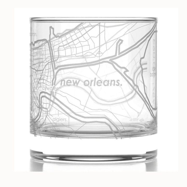 Etched glass rocks glass featuring a minimalist map of New Orleans including the Mississippi River and neighborhoods like Algiers and Bywater in a frosted finish with lowercase typography and a clear heavy-bottomed base