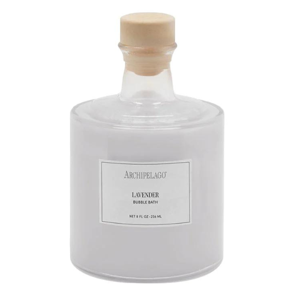 Studio photograph of Archipelago Lavender Bubble Bath in an eight-ounce cylindrical glass bottle on a white background featuring a light wood-toned cork stopper and a white rectangular brand label