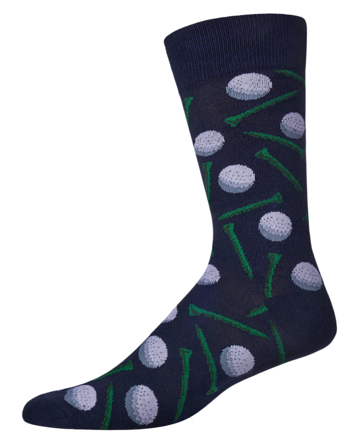 Product photograph of a navy blue knit dress sock set against a plain white background featuring a repeating pattern of dimpled white golf balls and vibrant green tees with a ribbed cuff