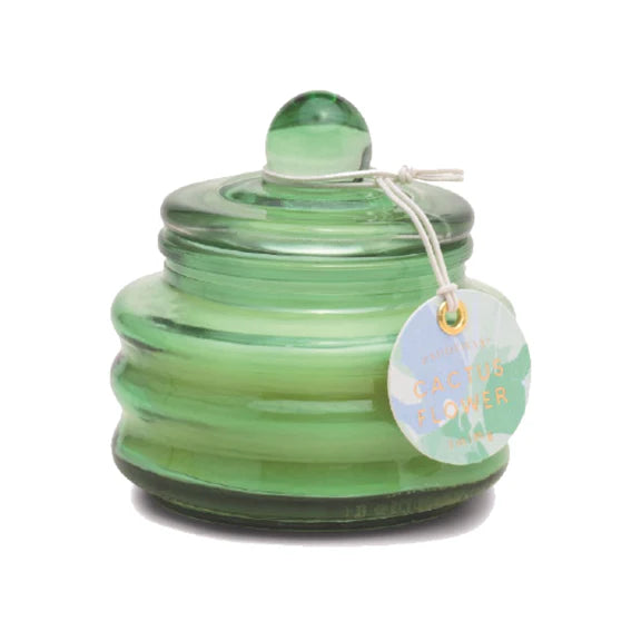 Sage green glass candle jar by Paddywax on a plain white background featuring a ribbed translucent finish, a spherical lid knob, and a circular Cactus Flower scent tag with gold lettering