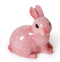 Polished pink stone rabbit figurine featuring a mottled rose and white speckled pattern and glossy black bead eyes on a stark white background