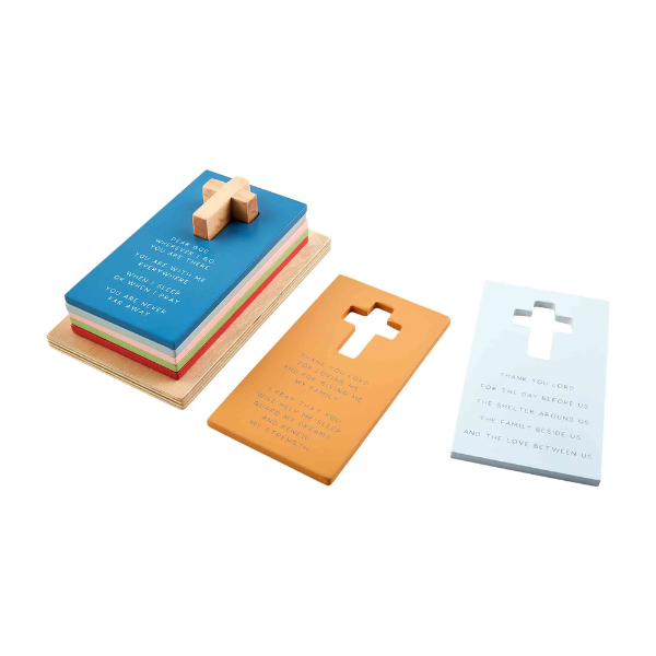 Wooden prayer block set featuring a stack of colorful rectangular cards alongside individual mustard and pale blue plates with engraved religious text and iconic cross cutouts on a white background