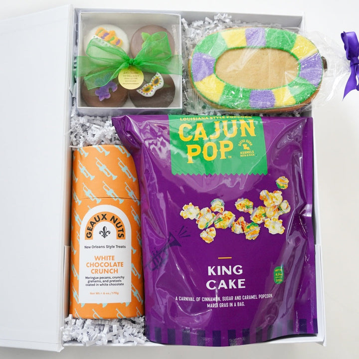 Gift box with Cajun Pop King Cake, GEAUX NUTS White Chocolate Crunch, and other items.