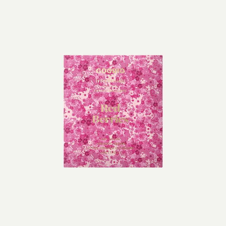 Packaging design by Goodio featuring a Red Berries craft chocolate bar centered on an ivory background with an intricate pink floral pattern and shimmering gold foil typography