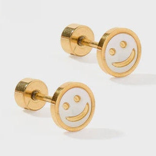 Gold-toned metal and white enamel stud earrings showcasing an iconic smiley face design on a light gray surface with glossy white centers and secure screw-on flat backings