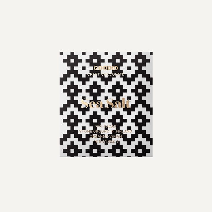 Graphic design packaging by Goodio features a Sea Salt chocolate bar from Finland highlighting a bold black and white pixelated geometric pattern, elegant gold foil typography, and a minimalist white background