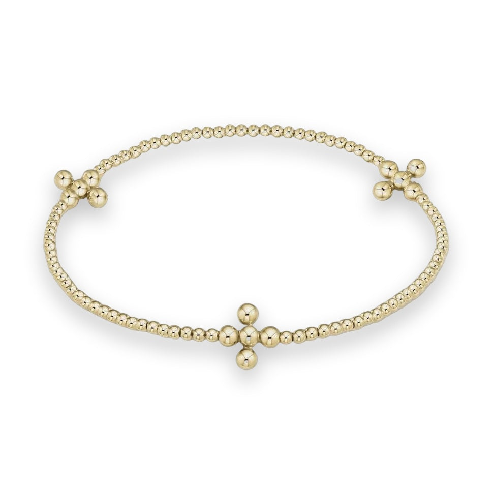 Yellow gold Perlée clovers bracelet by Van Cleef & Arpels featuring a sequence of polished spheres and three symmetrical clover-shaped motifs on a minimalist cream background