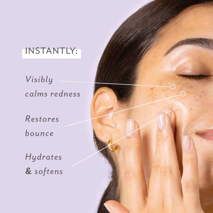 Digital skincare advertisement photograph of a woman with a freckled, dewy complexion against a light purple background featuring text overlays for skincare benefits alongside a gold hoop earring and manicured nails