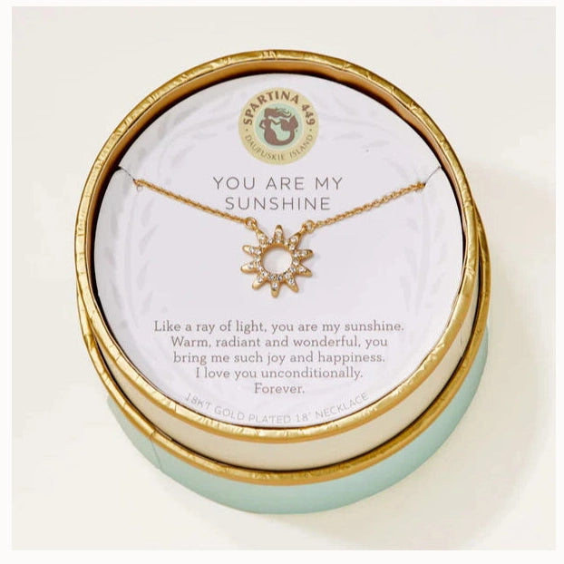 18kt gold plated necklace by Spartina 449 featuring a sun pendant with pavé-set crystals displayed in its circular gift box with the Daufuskie Island mermaid logo and You Are My Sunshine inscription over a mint green base