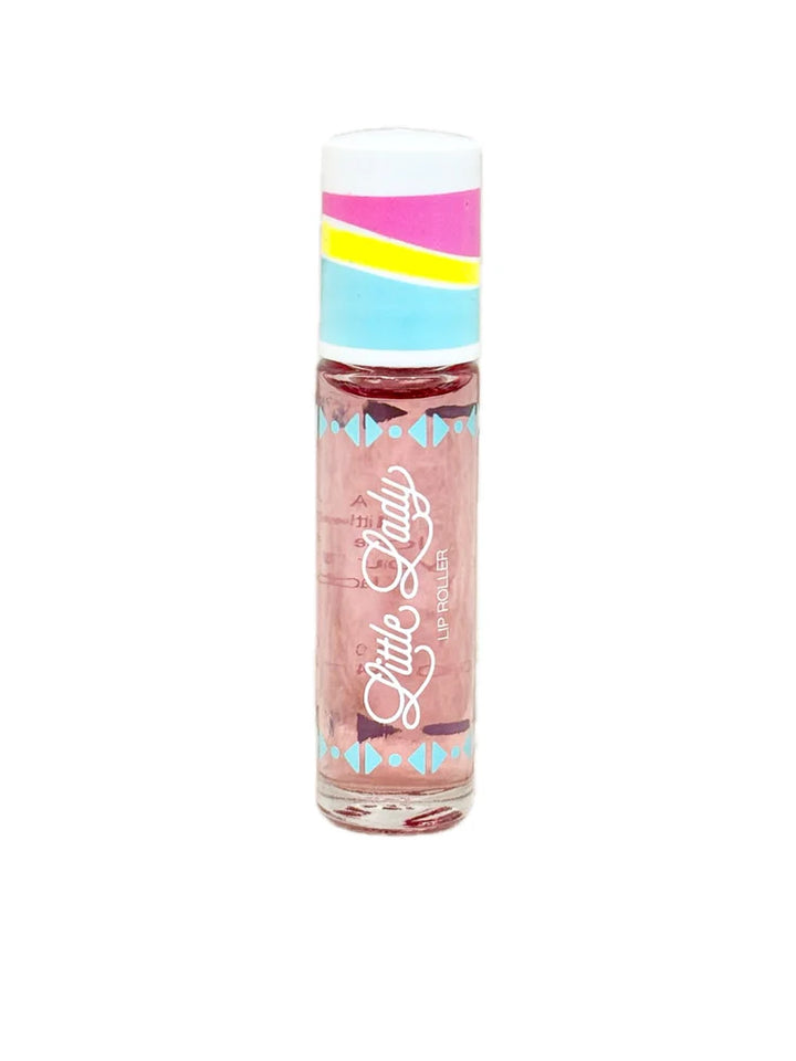 Commercial product photograph by Little Lady of a lip roller on a white background featuring a clear tube with pink-tinted liquid, a multi-colored cap with pink and yellow stripes, and blue geometric triangle patterns surrounding the iconic white cursive logo