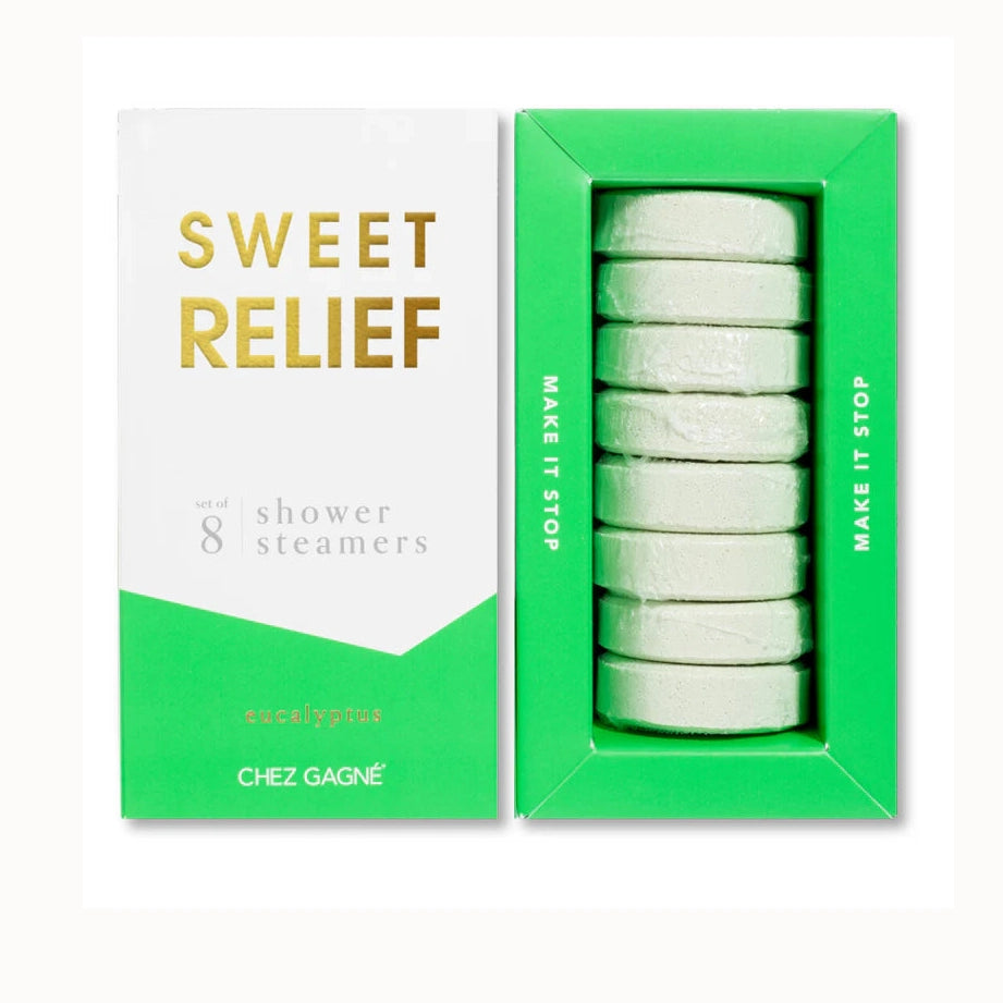 Digital photograph of Chez Gagné Sweet Relief eucalyptus shower steamers on a white background featuring eight pale green circular tablets in a vibrant green tray with gold foil lettering and the phrase Make It Stop