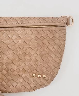 Studio photograph of a tan woven leather belt bag featuring a detailed intrecciato pattern, three small gold studs at the base, and a gold-toned zipper and side ring against a neutral background