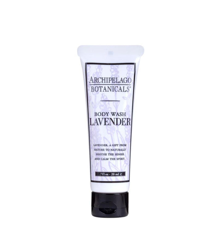 Studio product photograph by Archipelago Botanicals of a travel-sized lavender body wash tube centered on a white background, highlighting its purple botanical drawings, bold black branding, and a sleek black cap