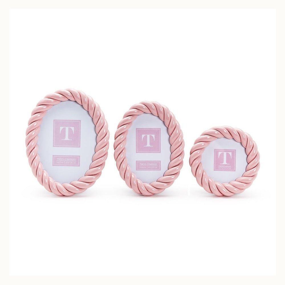 Two's Company set of three pink ceramic picture frames showcasing a glossy finish and textured twisted rope borders in graduated oval and round shapes on a white background