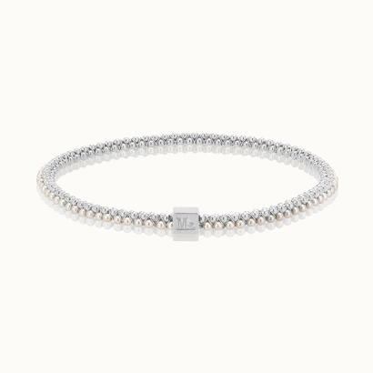 Polished silver beaded bracelet centered on a minimalist white background featuring a signature square engraved charm and double-layered rows of small spherical beads with a brilliant reflective finish