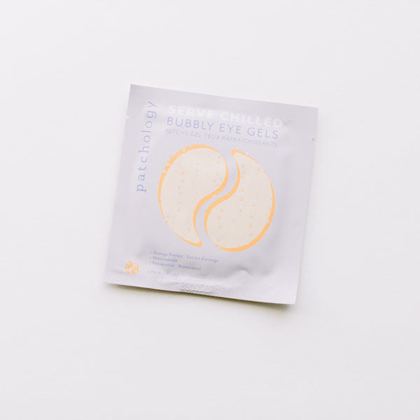 Product photograph of Patchology Serve Chilled Bubbly Eye Gels featuring a single white sachet with a champagne-gold gel patch illustration and delicate bubble details centered on a minimalist white background