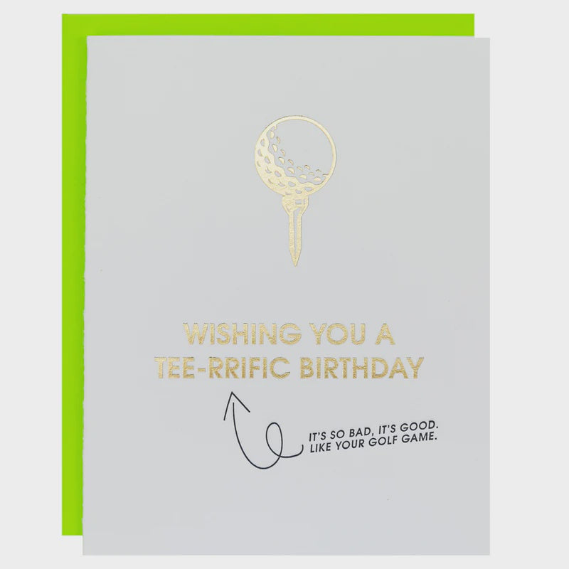 Foil-stamped greeting card features a golf-themed birthday design on grey cardstock including a gold foil golf ball on a tee, a vibrant lime green envelope, and a hand-drawn black arrow pointing to a humorous caption