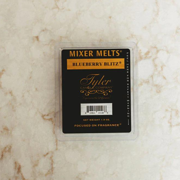 Product photograph of Tyler Candle Company Blueberry Blitz Mixer Melts featuring a black label with gold script and ornate flourishes resting on a light-colored marble surface