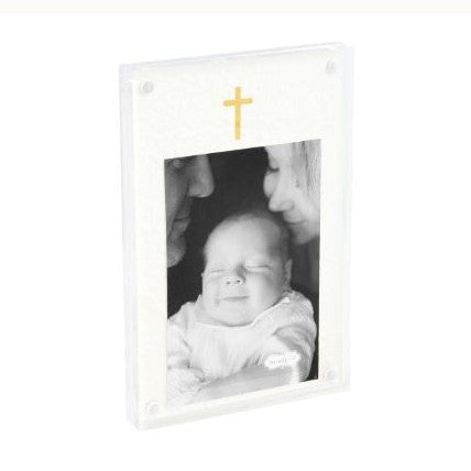 Acrylic photo frame by Mud Pie featuring a black and white baby portrait beneath a gold cross on a textured white mat within a thick clear magnetic block